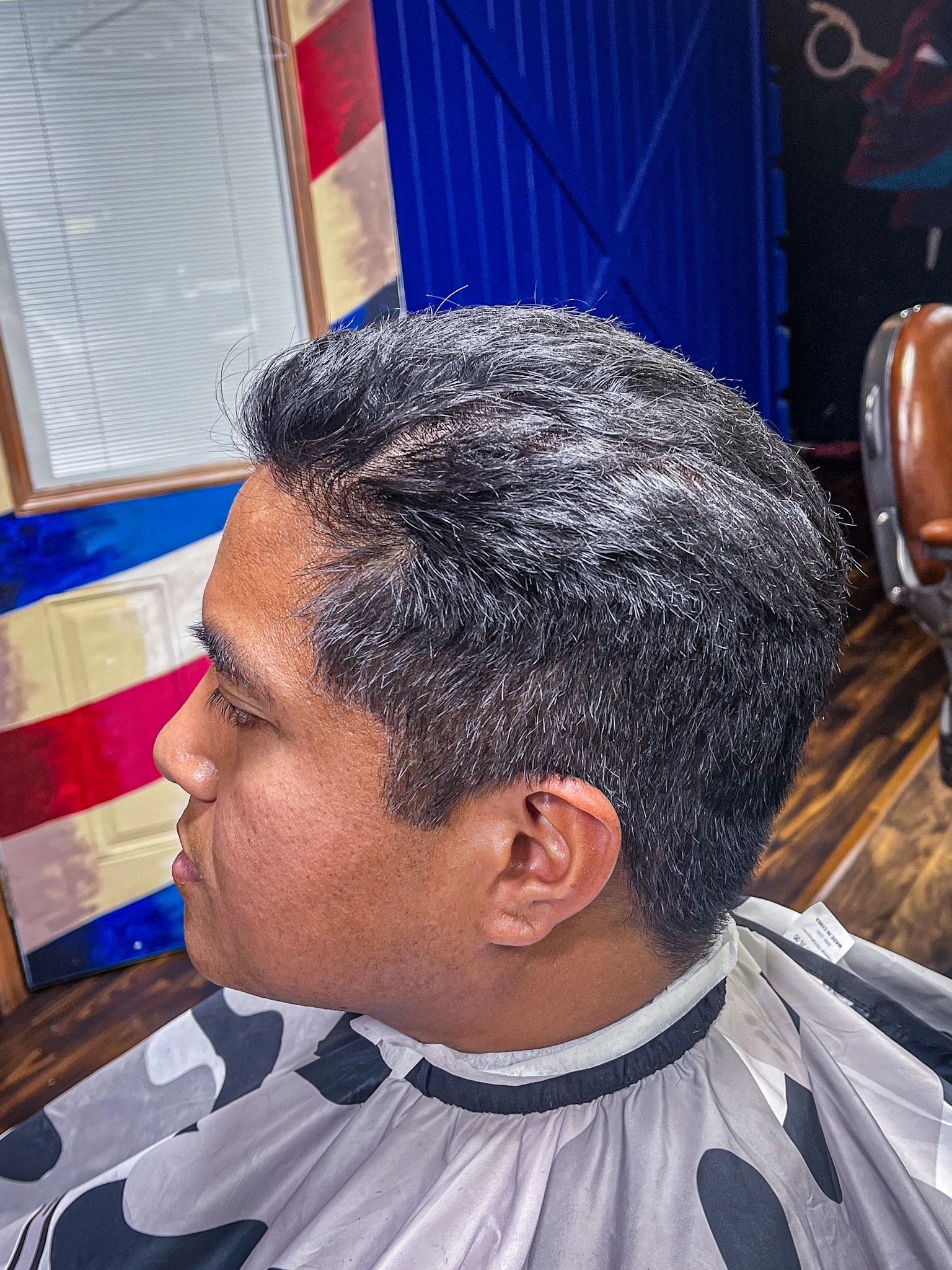 Pompadour with barber pole backdrop